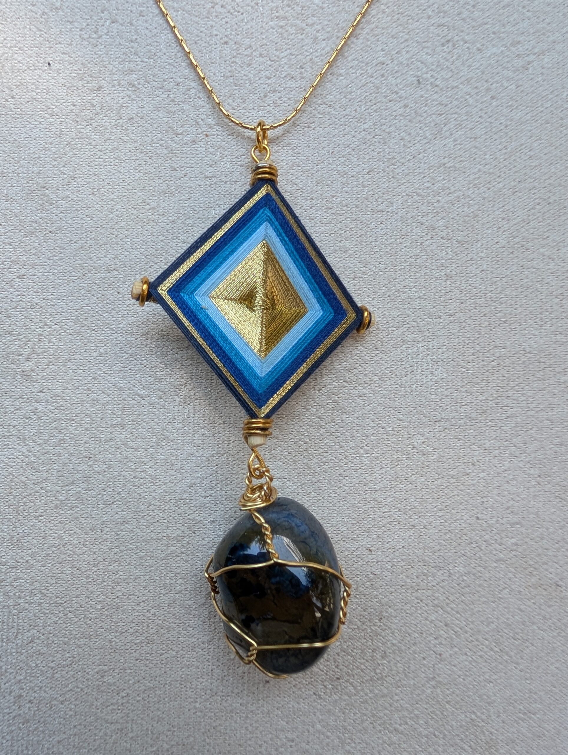 Pendentif artisanal élaboré en pierre naturelle et œil de Dieu. Fabrication artisanale au Mexique